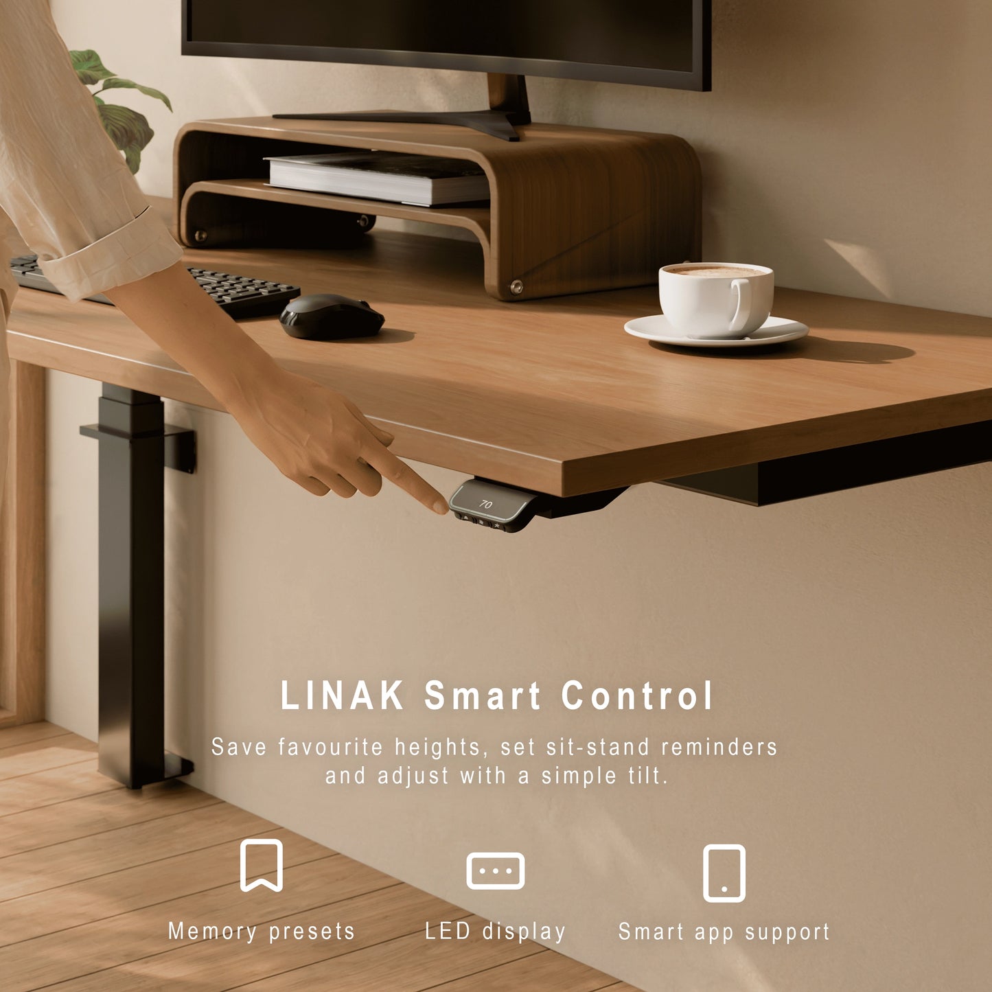 Close-up of LINAK Smart Control on a wall-mounted height adjustable desk with a person adjusting the height