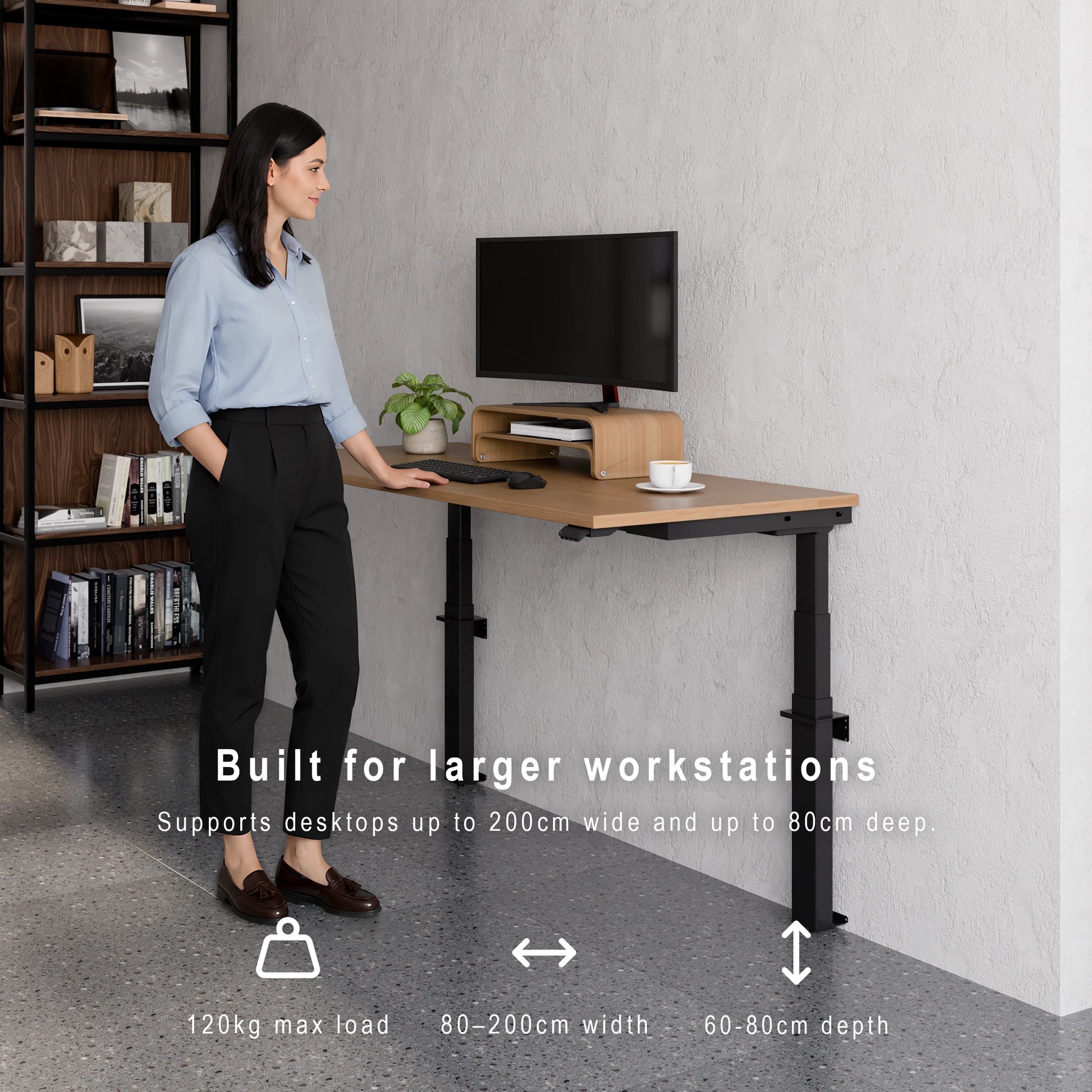 Large wall-mounted height adjustable desk supporting wide desktops, deep workstations and 120kg maximum load. Person standing at a adjustable desk with text highlighting its features.