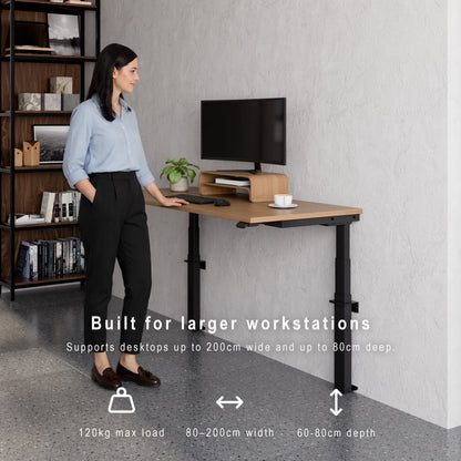 Large wall-mounted height adjustable desk supporting wide desktops, deep workstations and 120kg maximum load. Person standing at a adjustable desk with text highlighting its features.