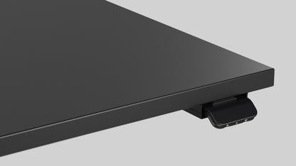 Close up of a LINAK DGG1C controller on LINAK Wall Solo height adjustable desk with black top, angled view