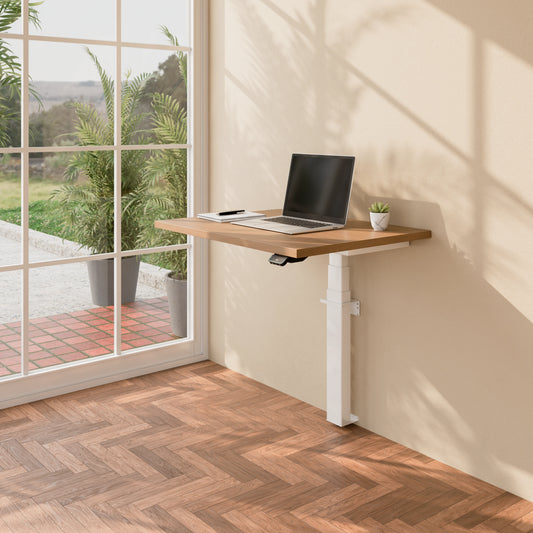 Angled view of the Linak Wall Solo adjustable desk with laptop and white frame