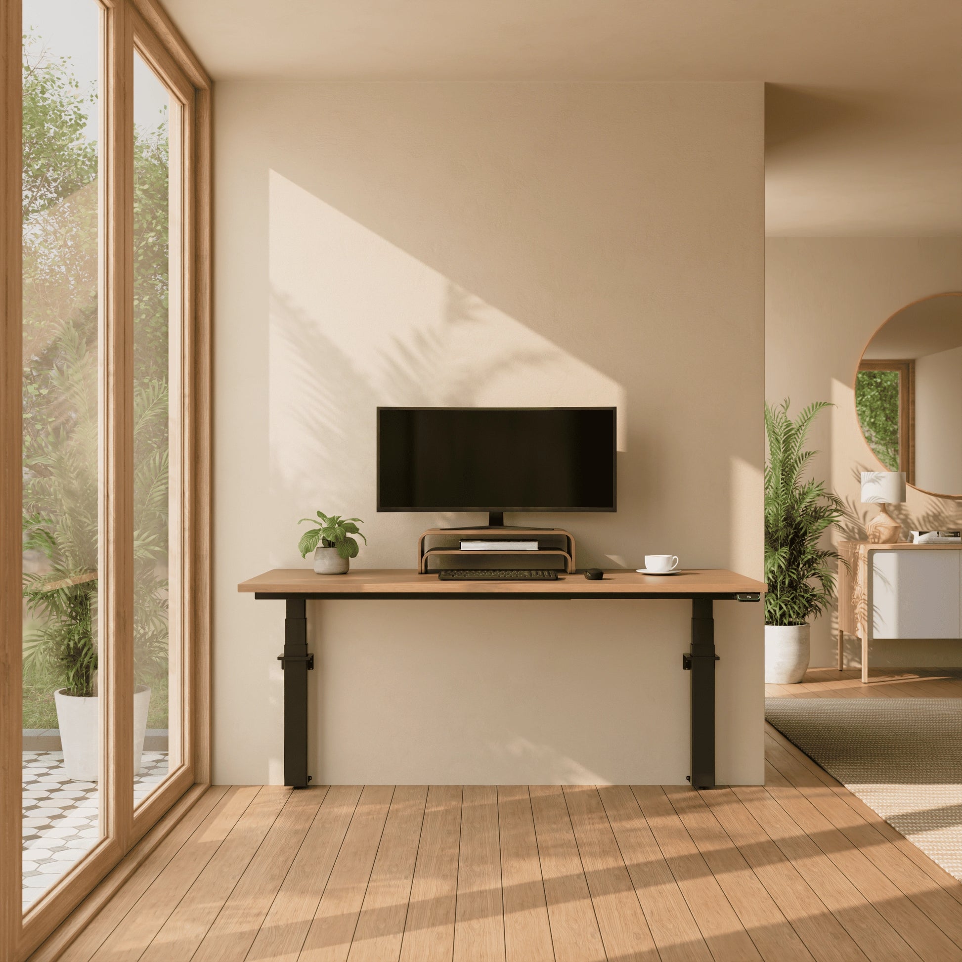A minimalist home office featuring a wall-mounted electric standing desk with an oak wood top and black legs against a beige wall.
